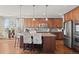 Modern kitchen with a center island, stainless steel appliances, and stylish pendant lighting at 2236 S Isabell Ct, Lakewood, CO 80228