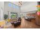 Open concept living room and kitchen with lots of natural light, hardwood floors, and comfortable furnishings at 2236 S Isabell Ct, Lakewood, CO 80228
