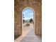 Inviting stone archway frames a scenic view of the Solterra community and distant mountains at 2236 S Isabell Ct, Lakewood, CO 80228