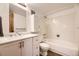 Bathroom with white cabinets, double sink, and tiled shower over tub at 2469 S Xanadu Way # A, Aurora, CO 80014
