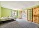 Bedroom with green walls, carpet, and arched doorway at 2469 S Xanadu Way # A, Aurora, CO 80014