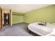 Bedroom with green walls, carpet and laundry closet at 2469 S Xanadu Way # A, Aurora, CO 80014