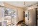 Sunlit kitchen area showcasing stainless steel refrigerator and sliding glass door with dark counter tops at 2469 S Xanadu Way # A, Aurora, CO 80014