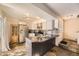 Well-equipped kitchen with island, stainless steel appliances, and tiled backsplash at 2469 S Xanadu Way # A, Aurora, CO 80014