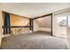 Carpeted loft area with railing, natural light, and wood paneled wall at 2469 S Xanadu Way # A, Aurora, CO 80014