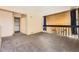 Spacious loft area featuring carpet, closet space, and wood accent wall at 2469 S Xanadu Way # A, Aurora, CO 80014