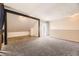 Loft featuring carpet and wood flooring with sliding glass door to balcony at 2469 S Xanadu Way # A, Aurora, CO 80014