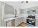 Modern kitchen featuring stainless steel appliances, gray cabinets and marble countertop at 3800 S Genoa Cir # C, Aurora, CO 80013