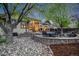 Charming backyard with a stone patio, outdoor seating, sunroom, and mature trees at 236 E Fair Ln, Centennial, CO 80121