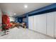 Finished basement with tile flooring, storage cabinets, and a seating area for relaxation at 236 E Fair Ln, Centennial, CO 80121