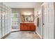 Bright bathroom featuring a glass block shower and double vanity sink at 236 E Fair Ln, Centennial, CO 80121