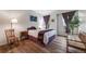Light-filled bedroom with hardwood floors and decorative accents at 236 E Fair Ln, Centennial, CO 80121