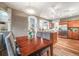 Dining area showcases hardwood floors, a chandelier, grey chairs, and kitchen access with lots of natural light at 236 E Fair Ln, Centennial, CO 80121