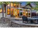Exterior view of the home featuring an outdoor patio with furniture and a sunroom at 236 E Fair Ln, Centennial, CO 80121