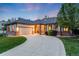 Charming ranch-style home features a manicured lawn and curved driveway leading to a two-car garage at 236 E Fair Ln, Centennial, CO 80121