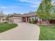 Inviting ranch home with a curved driveway, two-car garage, and brick accents at 236 E Fair Ln, Centennial, CO 80121
