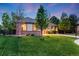 Beautiful home with brick accents, mature trees, and a lush green lawn at 236 E Fair Ln, Centennial, CO 80121
