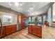 Bright kitchen offers modern appliances, wood cabinetry, island cooktop, eat-in dining area, and stylish track lighting at 236 E Fair Ln, Centennial, CO 80121