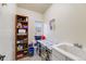 Functional laundry room with sink, shelving for storage, and a bright window at 236 E Fair Ln, Centennial, CO 80121