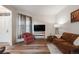 Cozy living room with laminate floors, lots of light, and an inviting seating arrangement at 236 E Fair Ln, Centennial, CO 80121