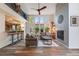 Bright living room with high ceilings, large windows, a fireplace, and a comfortable seating area at 236 E Fair Ln, Centennial, CO 80121
