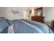 Comfortable main bedroom suite with hardwood floors, dresser, bedside table and natural light at 236 E Fair Ln, Centennial, CO 80121