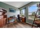 This home office boasts natural light, hardwood floors, a desk and bookcase, great for working from home at 236 E Fair Ln, Centennial, CO 80121