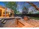 Outdoor patio featuring stone pavers, an outdoor dining area, and a sunroom at 236 E Fair Ln, Centennial, CO 80121