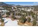 Aerial view of the home and surrounding neighborhood in the winter at 30544 The Golf Club Point, Evergreen, CO 80439