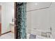 Full bath with shower and floral curtain detail at 30544 The Golf Club Point, Evergreen, CO 80439