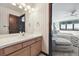 Bathroom vanity with bright lighting seen from bedroom at 30544 The Golf Club Point, Evergreen, CO 80439