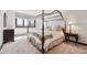 Bright bedroom with scenic views, four poster bed, and ample space for comfort and relaxation at 30544 The Golf Club Point, Evergreen, CO 80439