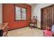 Cozy bedroom with natural light, stylish wallpaper, desk, chair, and red accent wall for a warm touch at 30544 The Golf Club Point, Evergreen, CO 80439