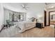 Serene bedroom offers cozy sitting nook with window, ceiling fan, and neutral palette for a peaceful retreat at 30544 The Golf Club Point, Evergreen, CO 80439