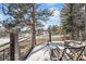 Enjoy serene outdoor living on this large deck with stunning views of snow-covered golf course and mountains at 30544 The Golf Club Point, Evergreen, CO 80439