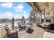 Inviting outdoor living space with comfortable seating, fireplace, and scenic mountain views at 30544 The Golf Club Point, Evergreen, CO 80439
