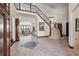 Grand foyer with soaring ceilings, decorative tile flooring, and a staircase with wrought iron railings at 30544 The Golf Club Point, Evergreen, CO 80439