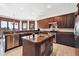 Gourmet kitchen featuring cherry wood cabinets, an island with a prep sink, and stainless steel appliances at 30544 The Golf Club Point, Evergreen, CO 80439