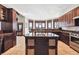 Spacious kitchen with dark wood cabinetry, granite countertops, an island, and stunning outdoor views at 30544 The Golf Club Point, Evergreen, CO 80439