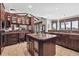 Well-appointed kitchen featuring wood cabinetry, an island with sink, and picturesque windows with scenic views at 30544 The Golf Club Point, Evergreen, CO 80439