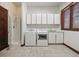 Convenient laundry room with modern washer, dryer, shower, sink and ample storage cabinets at 30544 The Golf Club Point, Evergreen, CO 80439