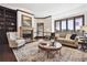 Bright living room features a fireplace, large windows with scenic views, and comfortable seating at 30544 The Golf Club Point, Evergreen, CO 80439