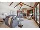 Cozy living room with vaulted ceilings, stone fireplace, built-in shelves, and comfortable seating at 30544 The Golf Club Point, Evergreen, CO 80439