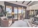Relaxing living room featuring exposed beams, large windows with scenic views, and comfortable furnishings at 30544 The Golf Club Point, Evergreen, CO 80439