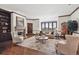 Elegant living room with hardwood floors, a fireplace, and a large bay window offering scenic views at 30544 The Golf Club Point, Evergreen, CO 80439