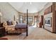 Spacious main bedroom boasts vaulted ceilings, a fireplace, and a sitting area with beautiful outdoor views at 30544 The Golf Club Point, Evergreen, CO 80439
