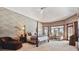 Elegant main bedroom suite featuring a four-poster bed, sitting area, and scenic views at 30544 The Golf Club Point, Evergreen, CO 80439