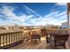 Spacious wooden deck featuring comfortable seating and views of the surrounding neighborhood and clear blue skies at 20341 E 48Th Pl, Denver, CO 80249