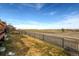 Backyard with a partial view of the adjacent open space with a walking path that goes into the distance at 20341 E 48Th Pl, Denver, CO 80249