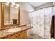 Cozy bathroom featuring a mosaic-tiled counter and a stylish shower curtain with a city print at 20341 E 48Th Pl, Denver, CO 80249
